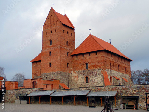 Reconstructed red buildings of the medieval Trakai castle in Lithuania. Impressive stone towers with red roofs. Most popular Lithuanian tourist destinations and Best Lithuanian sightseeings