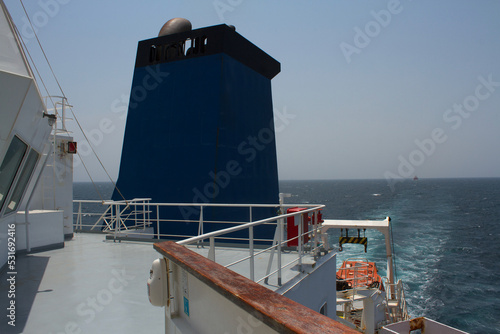 View of funnel and free fall life boat of a merchant ship at sea