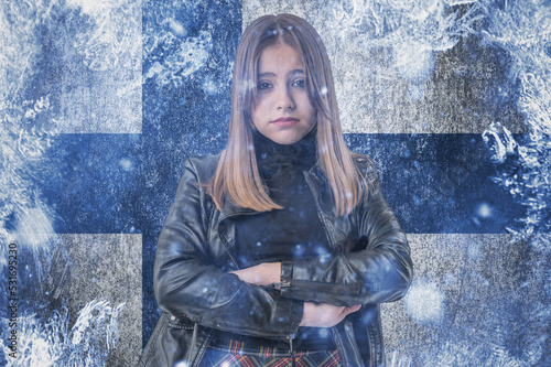 Teenage girl on frozen background with flag of Finland. Concept of crisis in Scandinavia in winter. Energy crisis.