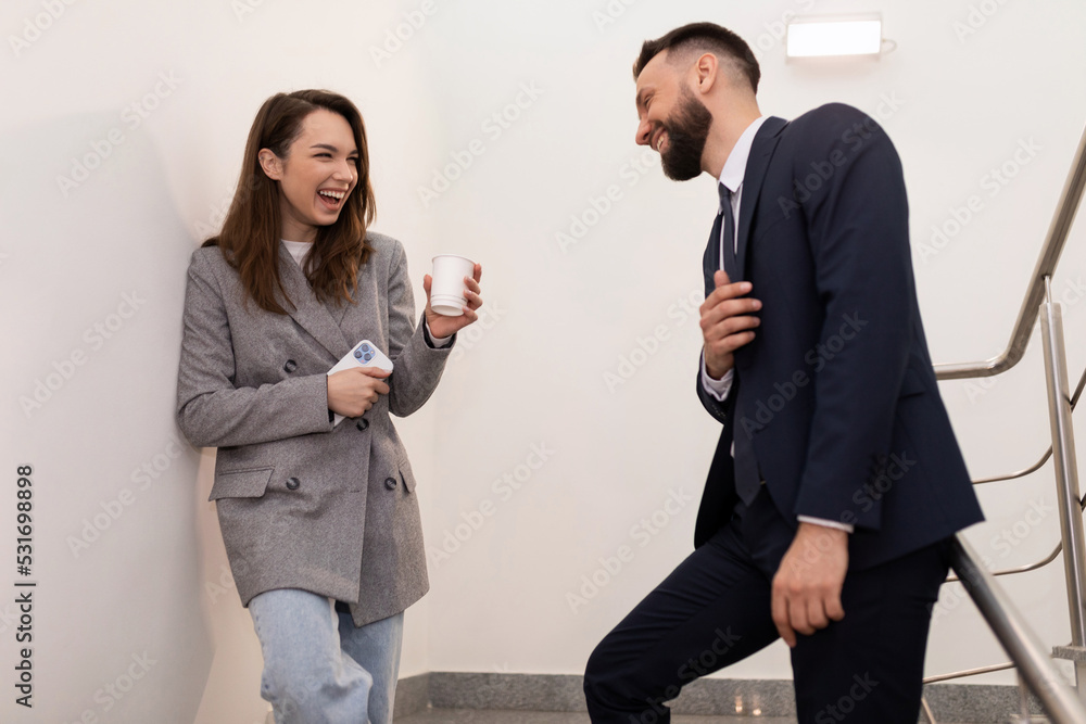 informal communication between a man and a woman during a lunch break in the office informal communication between a man and a woman during a lunch break in the office