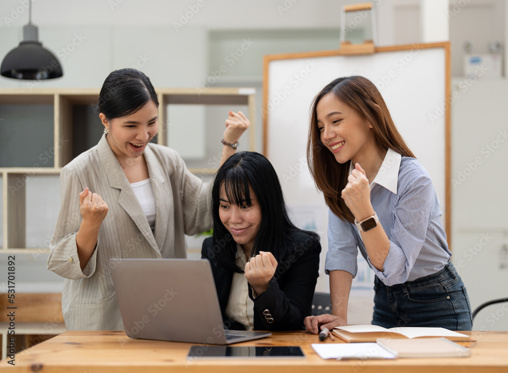 Happy business asian people are keeping arms raised hi five and expressing joyful while standing. achieving goals. Happy business asian people are keeping arms raised hi five and expressing joyful while standing. achieving goals.