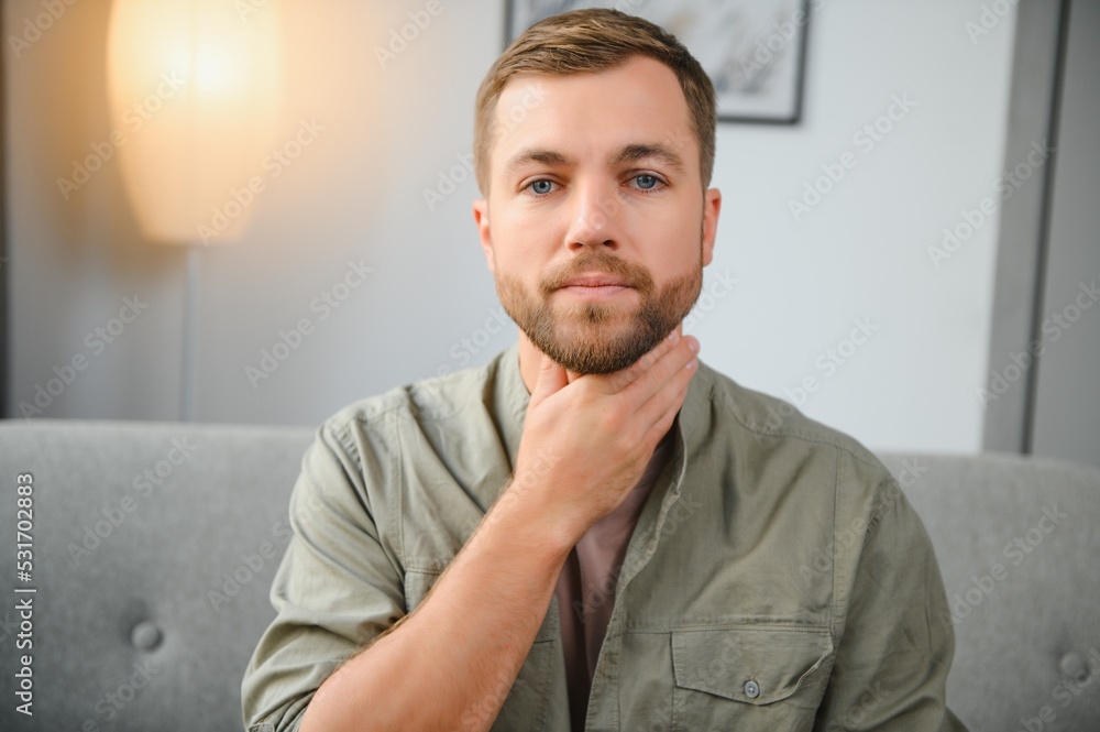 Obraz premium Sore throat. Dark-haired young man having a sore throat.