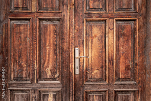 Old, rustic, classical, brown, wooden door with iron door handle. Door textures and background.