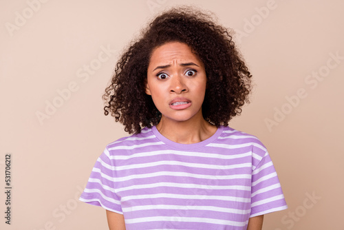 Photo of impressed frightened girl dressed purple t-shirt listening bed news isolated beige color background © deagreez