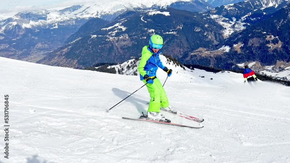 Fast action shoot of a boy moving downhill over alpine panorama Fast action shoot of a boy moving downhill over alpine panorama