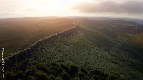 Cliff views in the Peak District.  Stanage Edge cliffs. Aerial footage of rock formation. Marsden Moor, Peak District National Park, United Kingdom.  photo