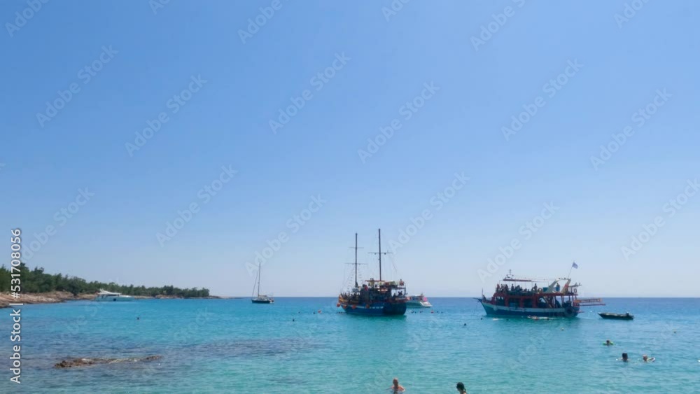 Summertime travel holidays landscape. Cruises tourist boats with people at beautiful bay turquoise color sea water scenery. Clear blue sky. Sunny summer day. 4K video. Summertime travel holidays landscape. Cruises tourist boats with people at beautiful bay turquoise color sea water scenery. Clear blue sky. Sunny summer day. 4K video.