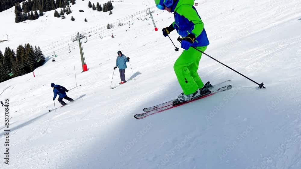 Boy ski downhill fast over beautiful forest on alpine resort Boy ski downhill fast over beautiful forest on alpine resort