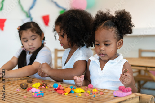 One Asian , Two African American little child girl playing together at home. Happy children girl having fun together