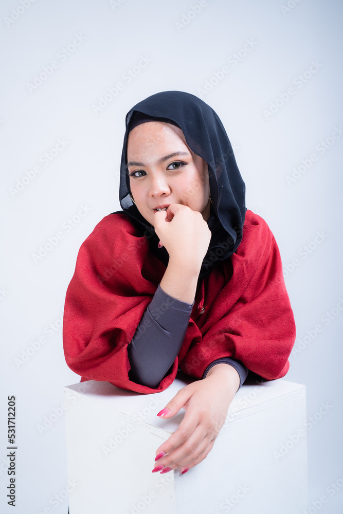 Portrait of a beautiful female Muslim model wearing hijab, a lifestyle apparel for Muslim women isolated from background. Modern hijab fashion concept. Portrait of a beautiful female Muslim model wearing hijab, a lifestyle apparel for Muslim women isolated from background. Modern hijab fashion concept.