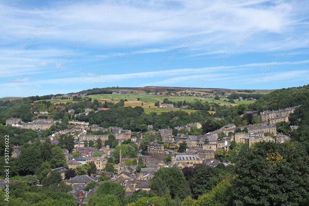 view of hebden bridge showing streets and the town centre surrounded by pennine countryside in summer sunlight