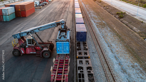 Aerial view crane loading container from container truck to container train, Cargo train with freight train container, Business import export logistic and transportation railway.