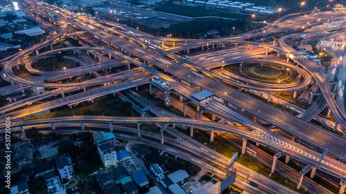 Aerial top view road roundabout interchange in city at night, Aerial view of highway and overpass in city at night.