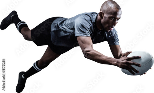 Foto Image of male african american rugby player in air holding ball