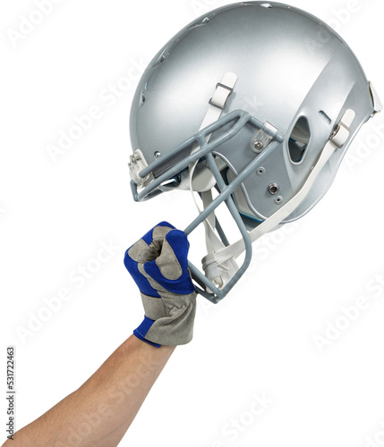 Image of caucasian american football player holding up silver helmet