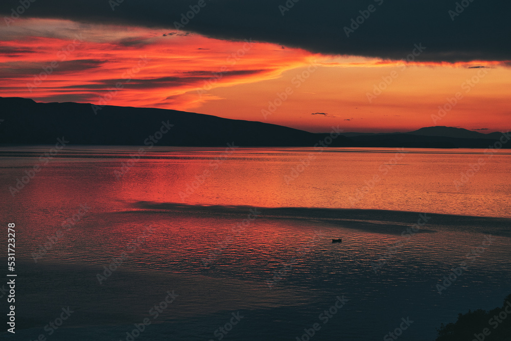 red sunset over the sea with mountains red sunset over the sea with mountains