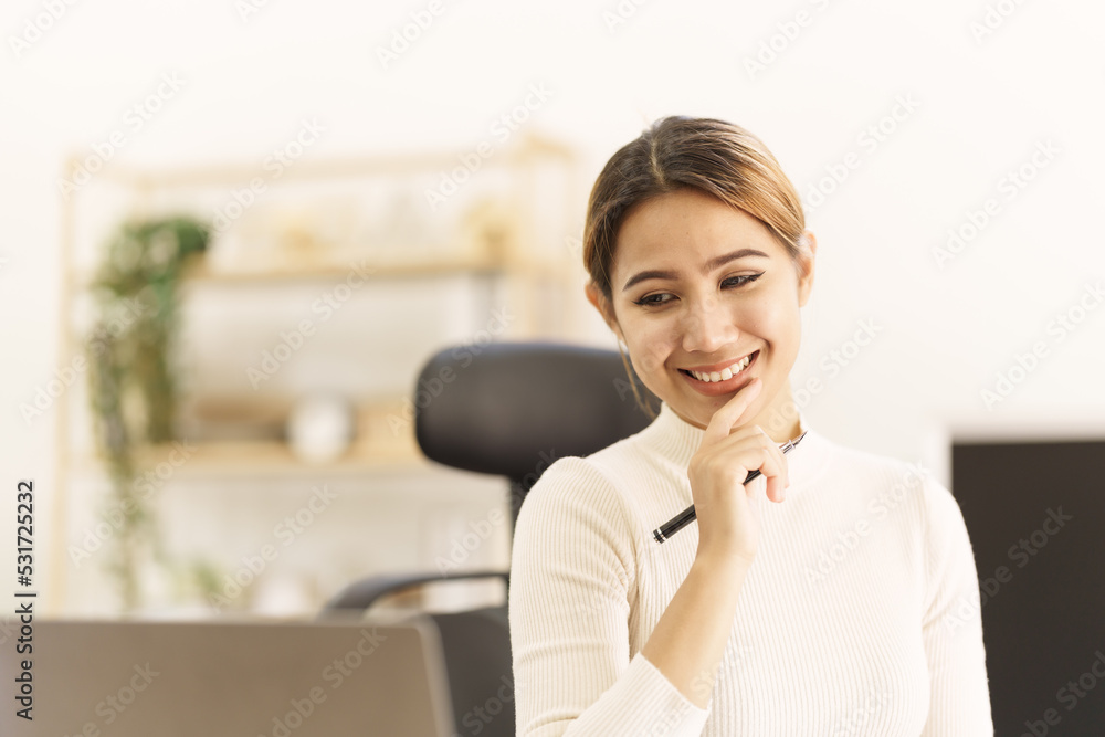 Asian thai businesswoman using laptop at working desk in modern office, busy job but feeling happy. Asian thai businesswoman using laptop at working desk in modern office, busy job but feeling happy.