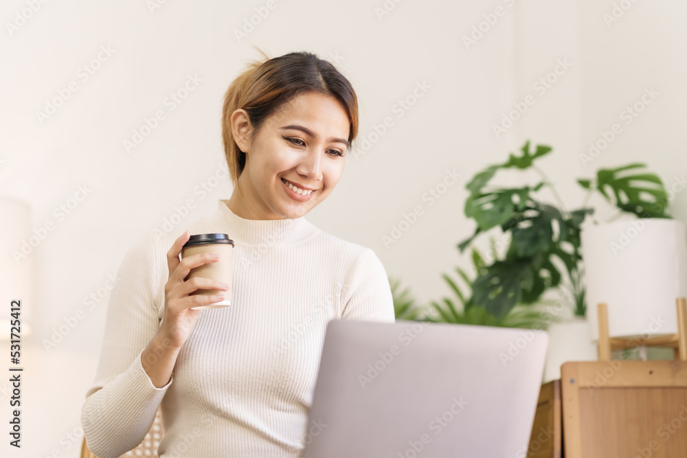 Asian thai businesswoman using laptop at working desk in modern office, busy job but feeling happy. Asian thai businesswoman using laptop at working desk in modern office, busy job but feeling happy.