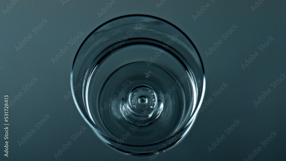 Water droplet falling cup top view. Pure liquid waving rippling in transparent Water droplet falling cup top view. Pure liquid waving rippling in transparent