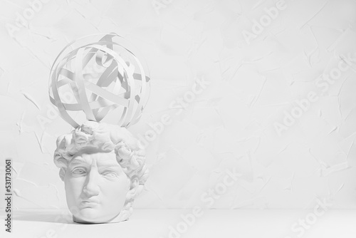 Idea and brainstorming abstract concept with image of creativity process as sphere of spinning thoughts around head of white thinking statue David. Idea of thinking and research solution. photo