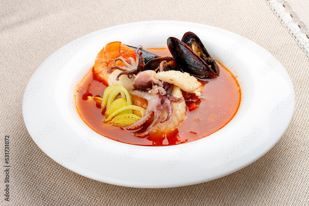 Traditional Marseille Bouillabaisse fish soup with prawns, mussels tomato,lobster, squid.