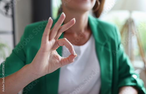 Business woman showing okay gesture in office
