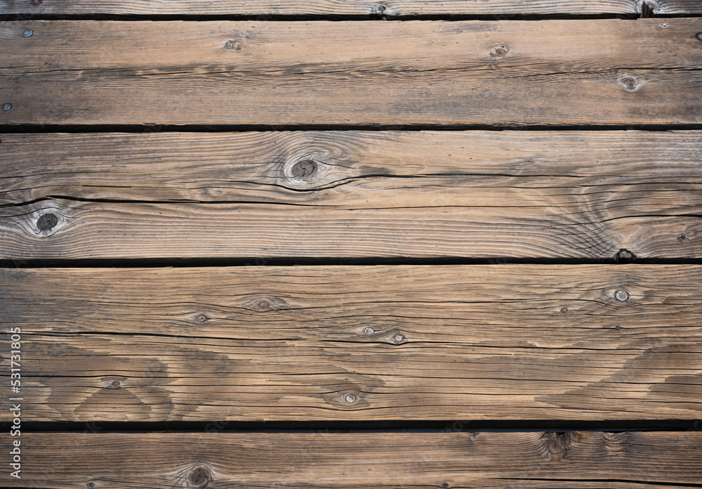 Top view of beautiful weathered brown spruce beams with knotholes and dark brown discoloration. Top view of beautiful weathered brown spruce beams with knotholes and dark brown discoloration.