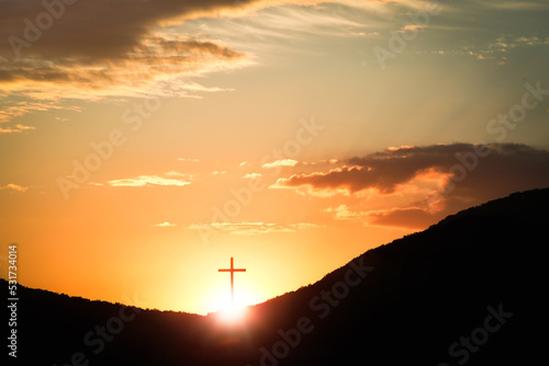 The sunset sky The red sun and clouds and the brightly shining cross of the Holy Church of Jesus Christ 
