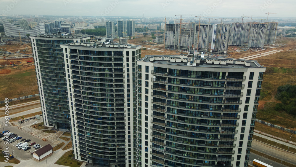 Construction site of a new city block. Construction of multi-storey buildings. Overcast weather. Aerial photography. Construction site of a new city block. Construction of multi-storey buildings. Overcast weather. Aerial photography.