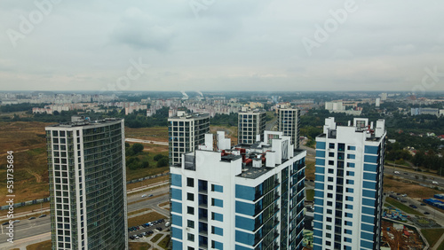 Construction site of a new city block. Construction of multi-storey buildings. Overcast weather. Aerial photography.