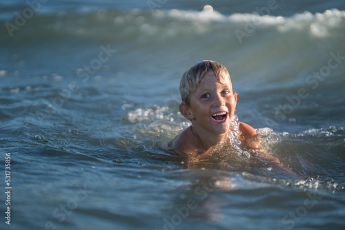 Happy little boy laughing on the shore, Child enjoying active summer, holiday in beach resort. summer concept holiday, Emilia Romagna, Italy. © robertobinetti70