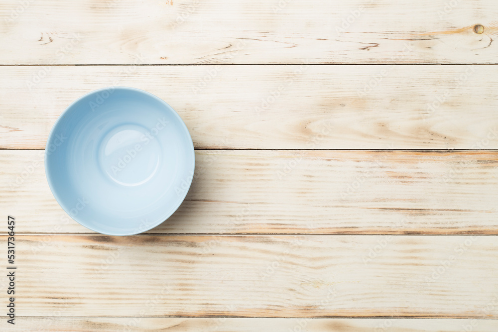 Empty round plate on wooden background, top view Empty round plate on wooden background, top view