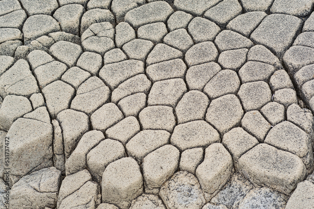 natural stone background, the remains of lava basalt columns form a kind of cobblestone causeway natural stone background, the remains of lava basalt columns form a kind of cobblestone causeway