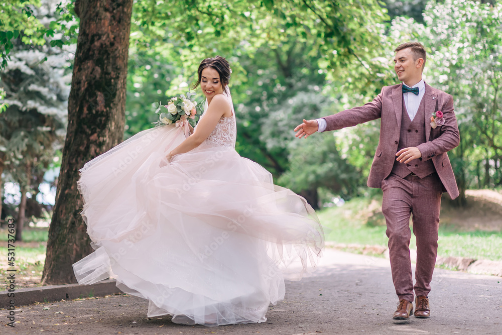 newlyweds in love are dancing together on a city street on a sunny day - the concept of people, love and holidays newlyweds in love are dancing together on a city street on a sunny day - the concept of people, love and holidays