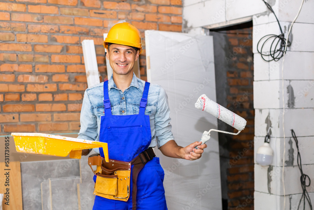 Handsome young man builder installing Handsome young man builder installing