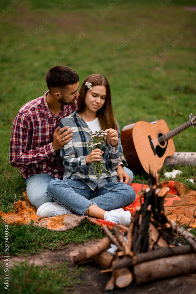beautiful close-up view of young couple relaxing in the park. Love story. beautiful close-up view of young couple relaxing in the park. Love story.