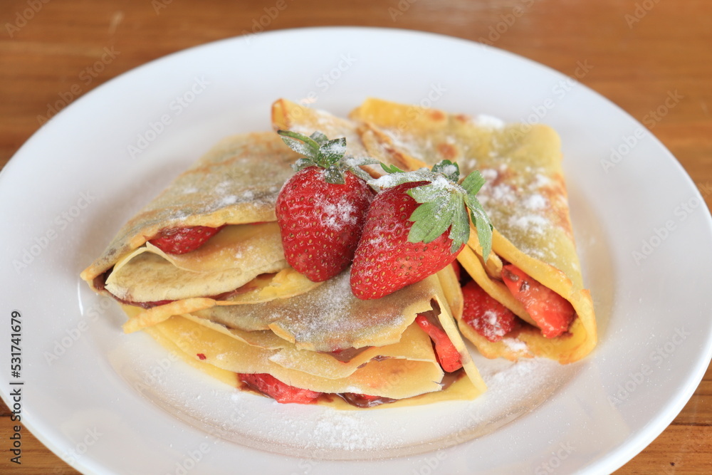 dessert, sandwich with strawberries and powdered sugar, on a white plate dessert, sandwich with strawberries and powdered sugar, on a white plate