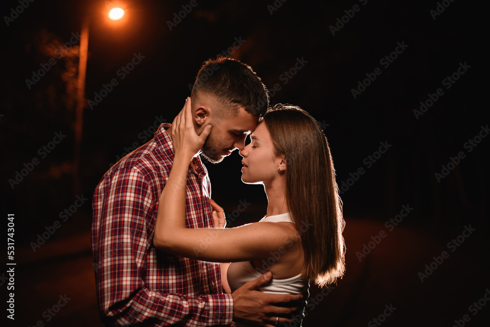 side view of attractive young couple flirting and looking each other side view of attractive young couple flirting and looking each other