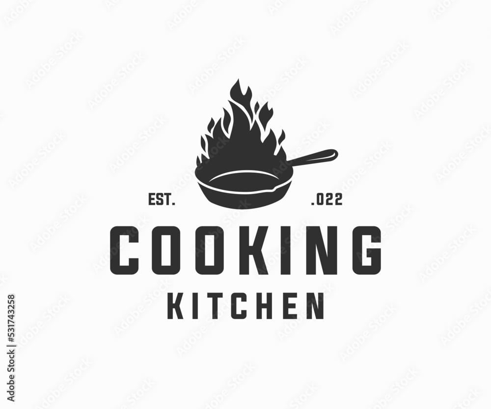 Skillet cast iron with fire logo design. Classic restaurant kitchen logo Skillet cast iron with fire logo design. Classic restaurant kitchen logo