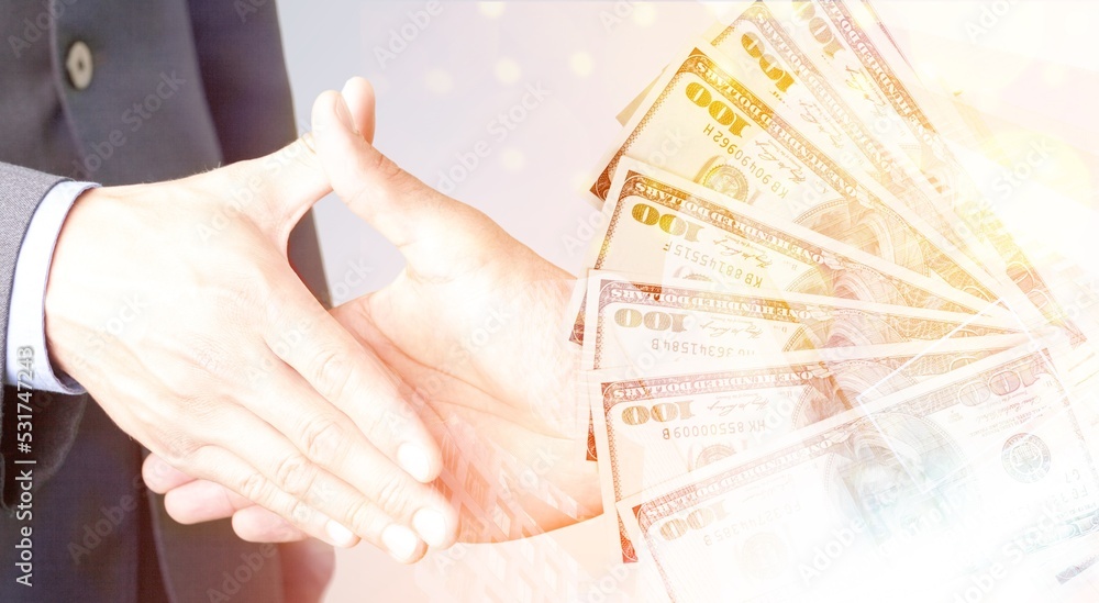 Bussines man shakes hand of a partner with a money Bussines man shakes hand of a partner with a money