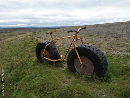 Large bike constructed out of tractor wheel and custom frame