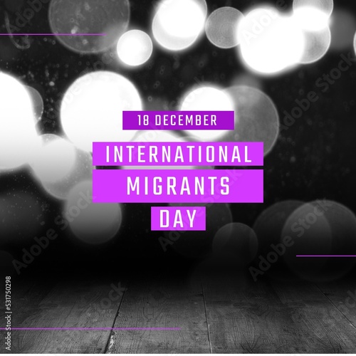 Composition of international migrants day text over black and white photo of bokeh lights