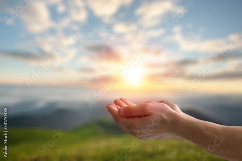 Christian person hands pray on nature background..