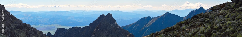 Mountain panorama.  Mountain rocky landscape. Panoramic photo of mountain peaks and valleys. Majestic view of the rock peaks. High-resolution picture. Real photo of Tatra Mountains in Slovakia.