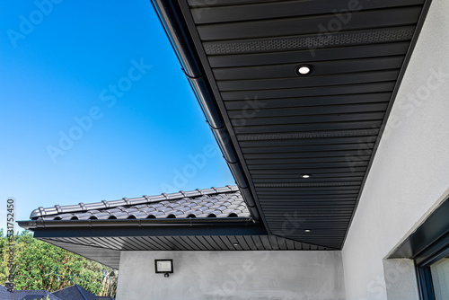 A modern graphite herringbone roof lining is attached to the trusses, visible turned on LED lights. photo