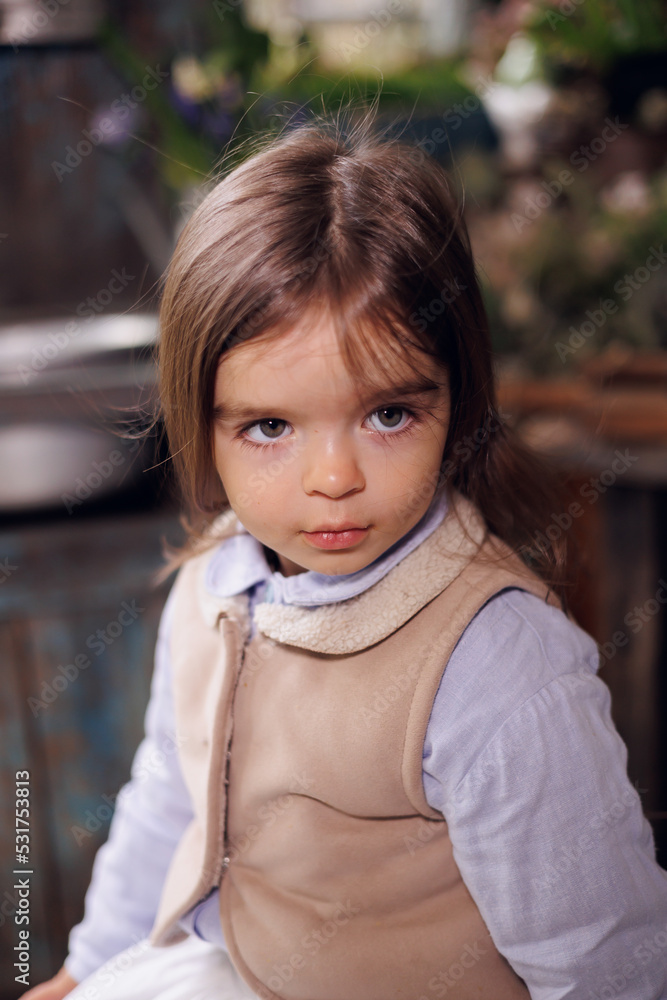 little pretty girl portrait. baby child of 3 years old in retro vintage dress sitting on wooden terrace. little pretty girl portrait. baby child of 3 years old in retro vintage dress sitting on wooden terrace.