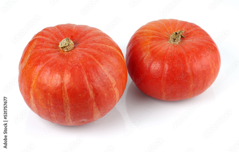 Two red pumpkins isolated on a white background. Selective focus. Two red pumpkins isolated on a white background. Selective focus.