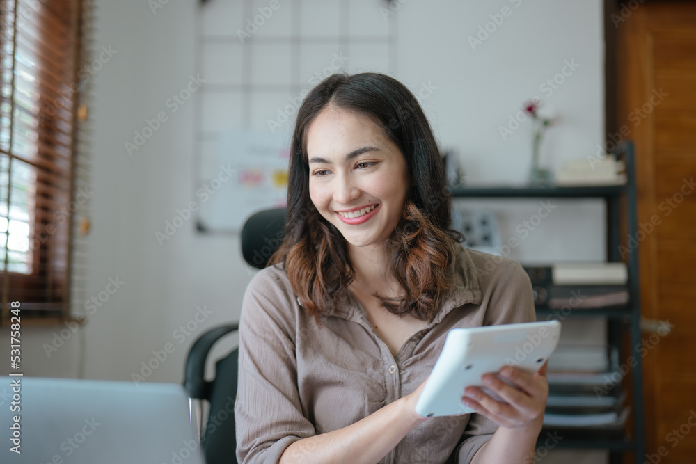 Young business women working and calculating on laptop with happy and smile face on office spec. Young business women working and calculating on laptop with happy and smile face on office spec.