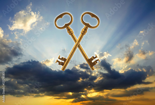 Two golden keys at sunset photo