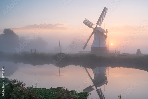 Tranquil, foggy dawn at a windmill (Witte Molen) in the Netherlands.